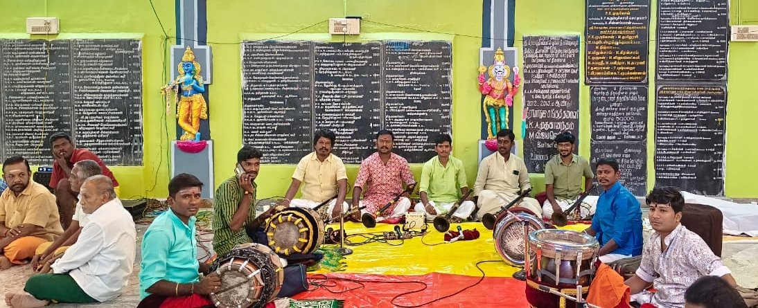 Full ensemble at temple hall with deities